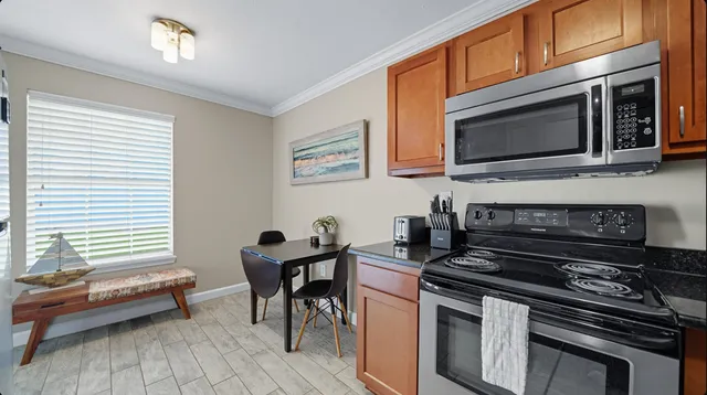 a kitchen with stainless steel appliances granite countertop a refrigerator stove top oven and sink