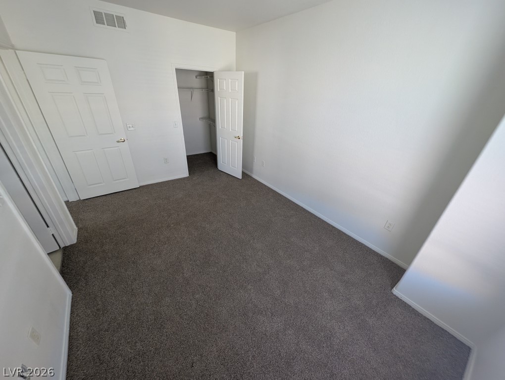10550 West Alexander Road, Unit 2117 Las Vegas, NV 89129 - Photo 20 of 24 A versatile bedroom features neutral plush carpeting and a convenient walk-in closet.