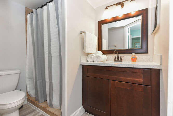 150 Pineview Road, Unit L6 Jupiter, FL 33469 - Photo 11 of 22 a bathroom with a toilet sink and mirror