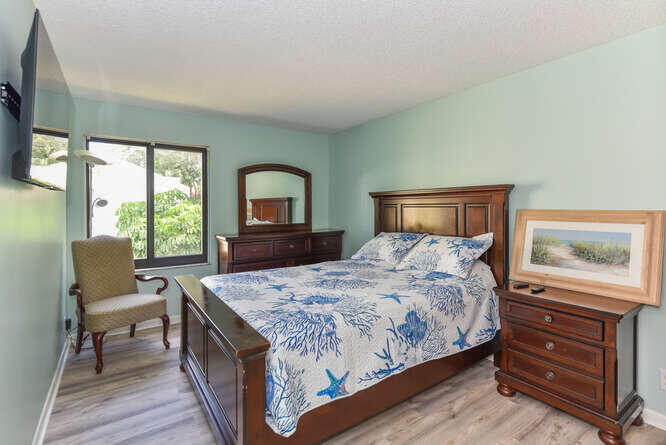 150 Pineview Road, Unit L6 Jupiter, FL 33469 - Photo 13 of 22 a bedroom with a bed and a dresser next to a window