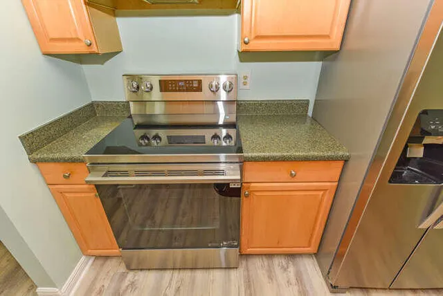 a stove top oven sitting inside of a kitchen