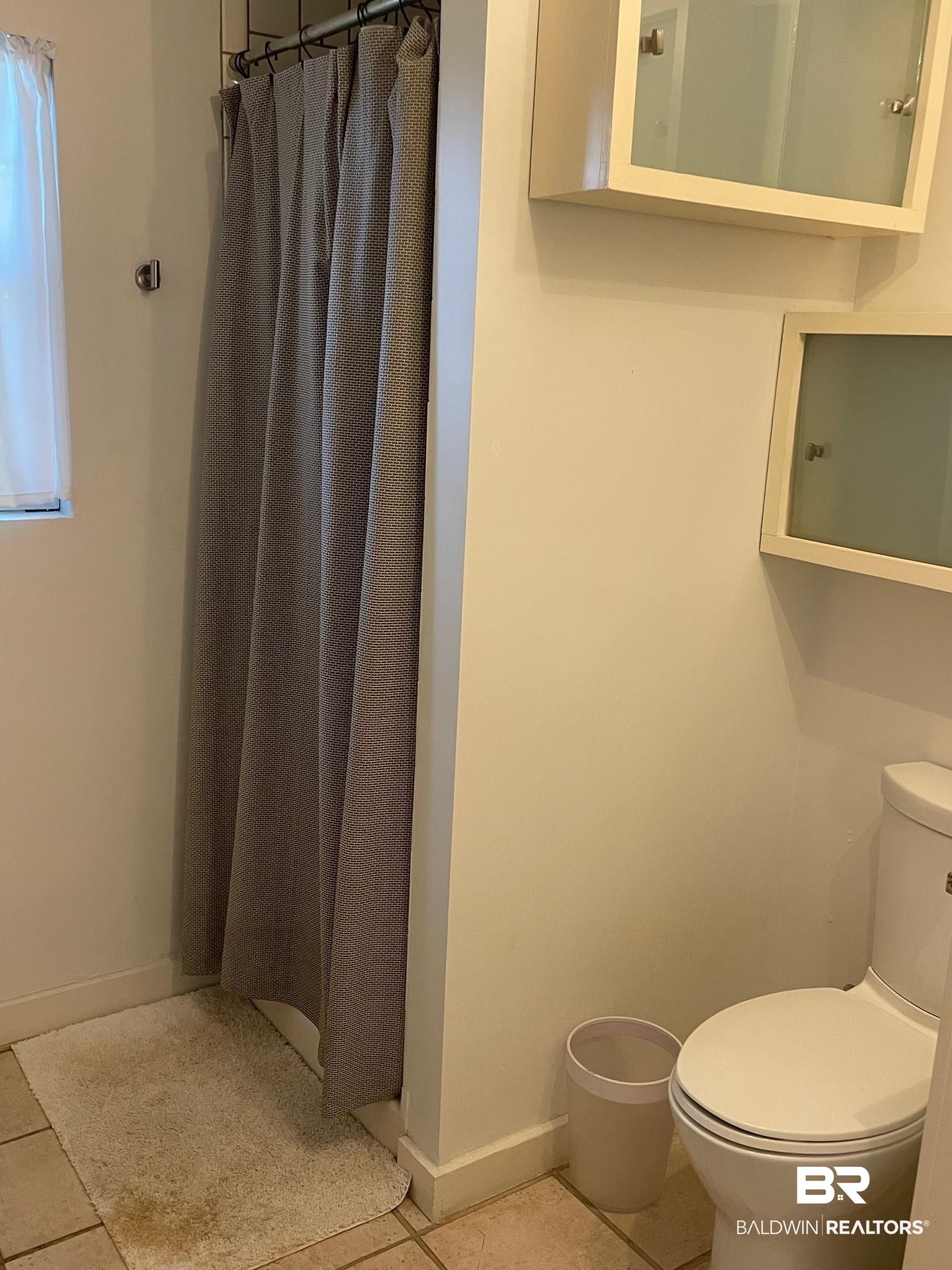 20 Lancaster Road Mobile, AL 36608 - Photo 9 of 13 Bathroom with walk in shower, toilet, and tile patterned flooring