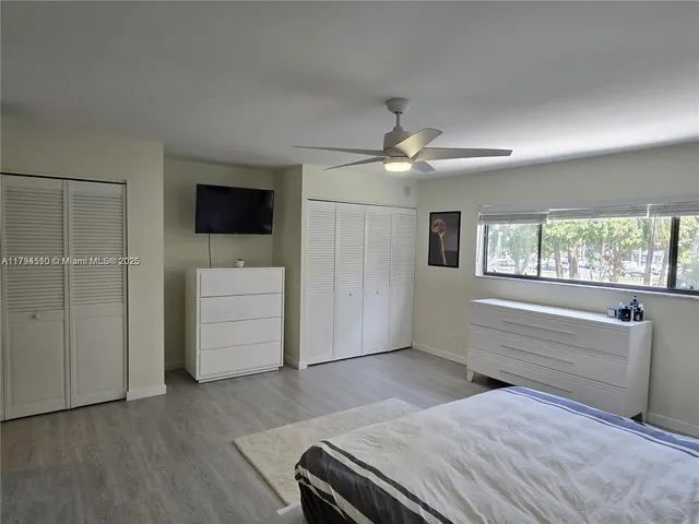 a bedroom with a bed and a ceiling fan