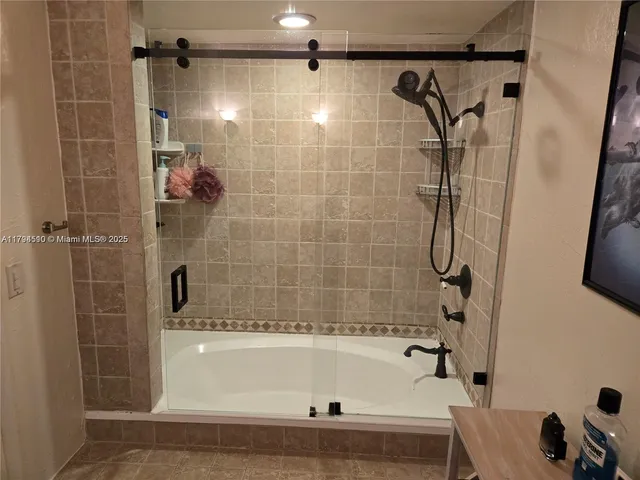a bathroom with a shower and a bath tub