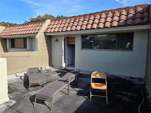 a patio with table and chairs