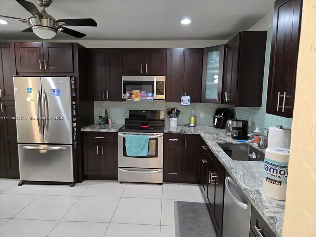 a kitchen with a refrigerator sink and microwave