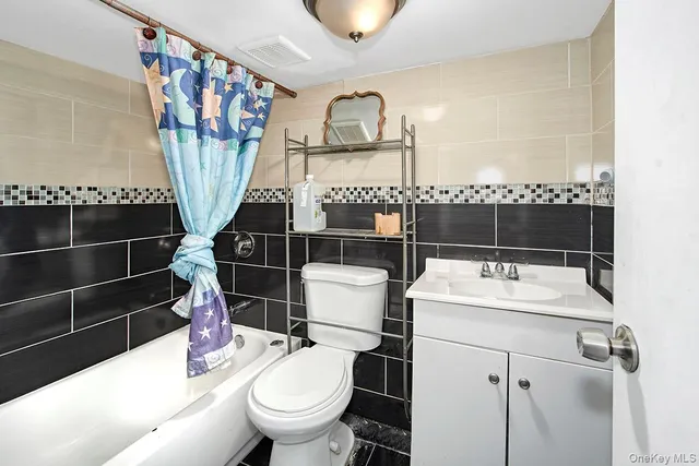 a living room with furniture a flat screen tv and a sink