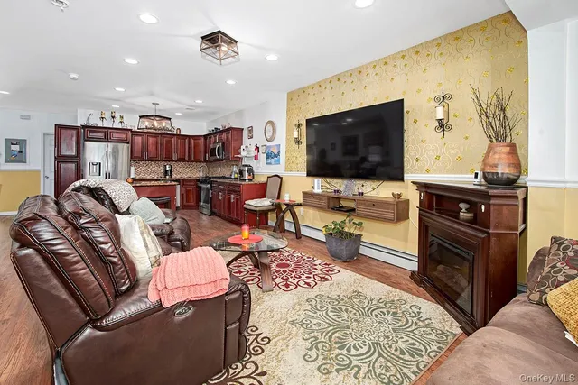 a living room with furniture wooden floor and a flat screen tv