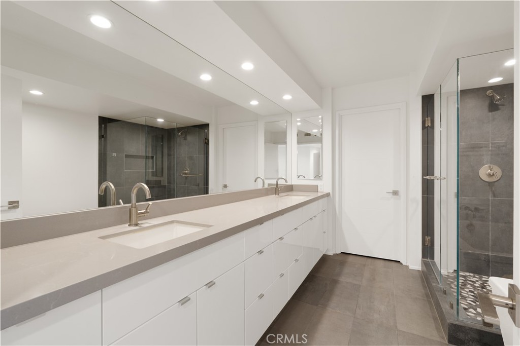 222 Monterey Road, Unit 901 Glendale, CA 91206 - Photo 50 of 68 a bathroom with a double vanity sink and a mirror