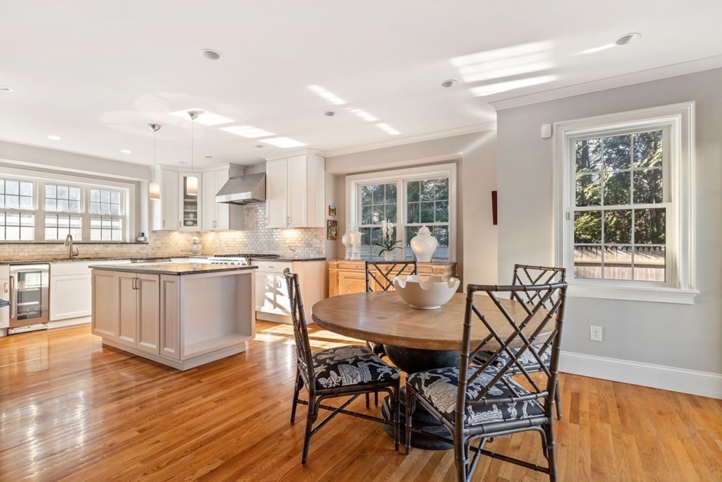 23 Thomas Road Wellesley, MA 02482 - Photo 8 of 23 a dining area with granite countertop a stove top oven a sink dishwasher a dining table and chairs with wooden floor