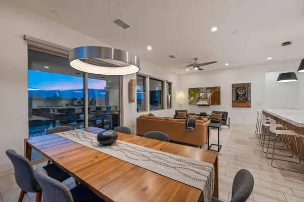 a view of a dining room with furniture a chandelier and wooden floor