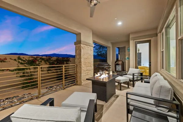 a view of a couches and dinning table in a balcony
