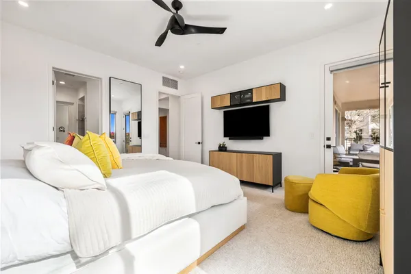 a living room with furniture a ceiling fan and a window