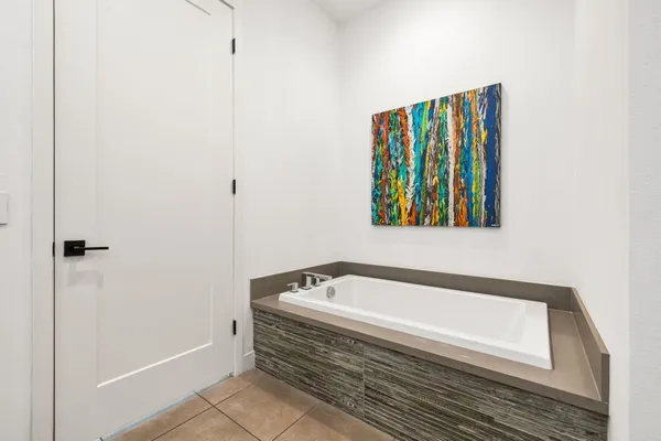 a spacious bathroom with a granite countertop sink a mirror and a