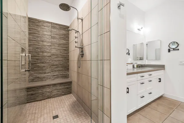a bathroom with a shower sink and mirror