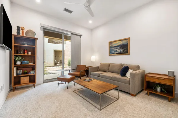 a view of a livingroom with furniture and an empty room