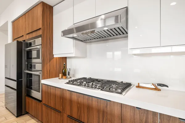 a kitchen with a refrigerator and a sink
