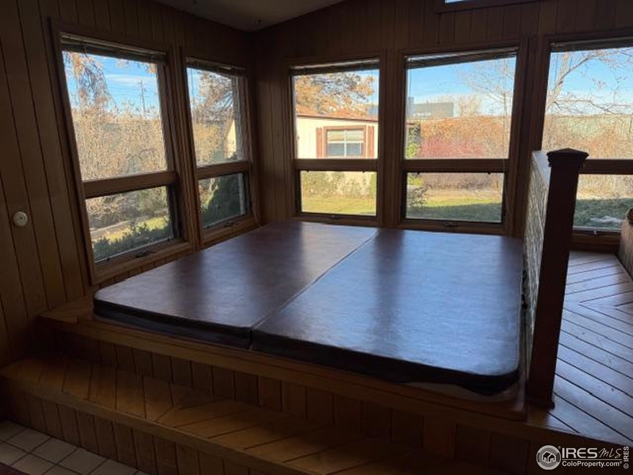 10357 Monterey Circle Northglenn, CO 80260 - Photo 10 of 18 an empty room with wooden floor and windows