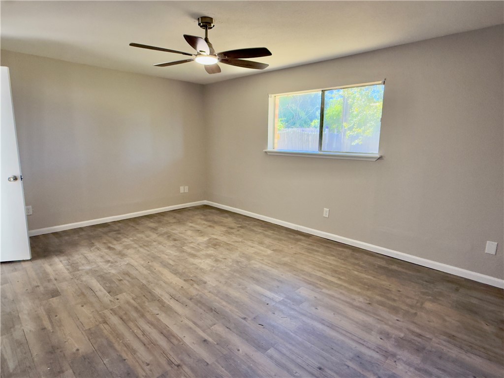 4006 Easy Street Corpus Christi, TX 78418 - Photo 3 of 8 a view of an empty room with wooden floor and a window