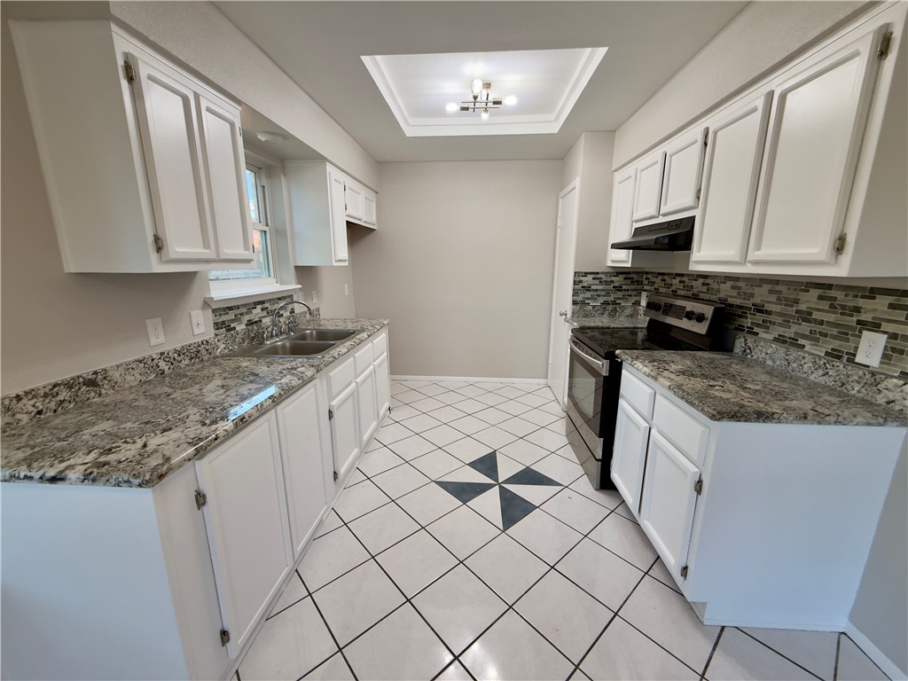 4006 Easy Street Corpus Christi, TX 78418 - Photo 4 of 8 a kitchen with granite countertop white cabinets and stainless steel appliances