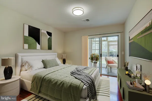 a bedroom with a bed and glass door