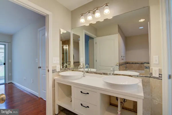 a bathroom with a sink double vanity and a mirror