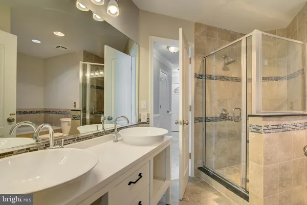 a bathroom with a sink double vanity and a shower