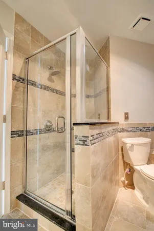 a bathroom with a granite countertop shower a mirror and a sink