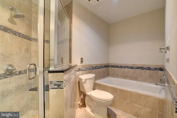 a bathroom with a tub a toilet and a sink