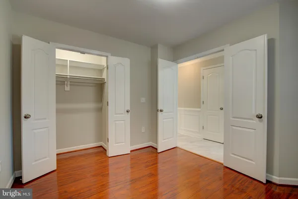 a view of an empty room and wooden floor