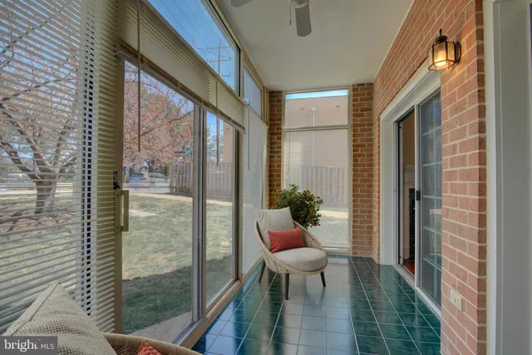 a porch with a table and chairs