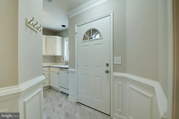 a hallway with cabinets and a stove
