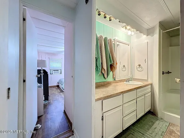 a view of a bathroom with a sink and mirror