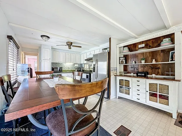 a large kitchen with a table and chairs