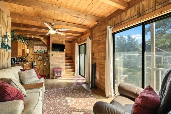 a living room with furniture and a floor to ceiling window