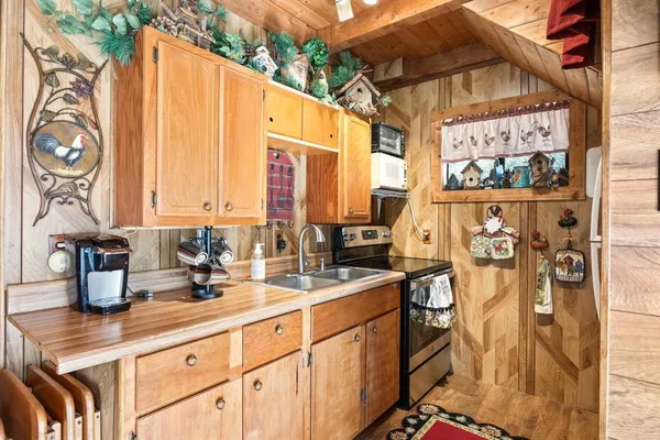 a kitchen with stainless steel appliances a sink a counter top space and a window