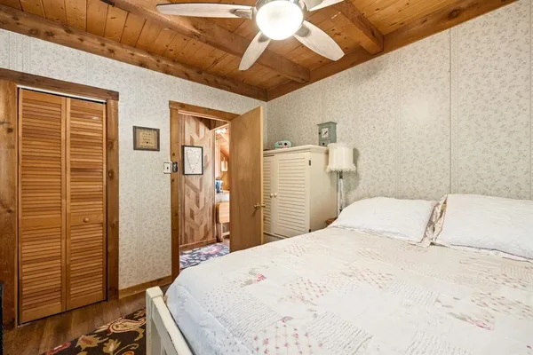 a bedroom with a bed and a chandelier