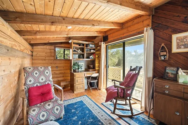 a view of a chairs and table in the balcony