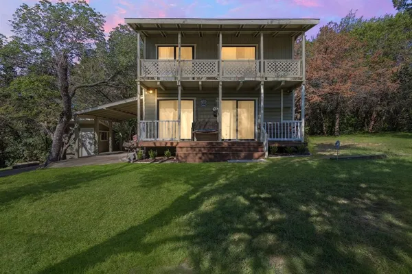 a front view of a house with a yard and porch
