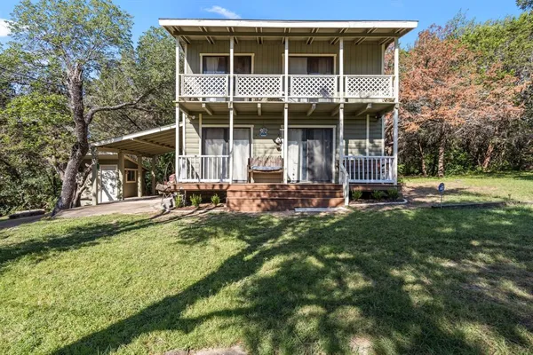 a view of a house with backyard and sitting area
