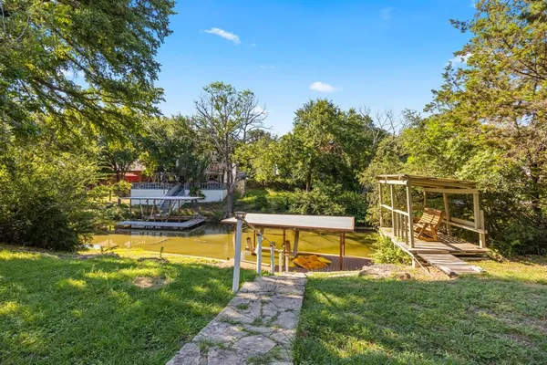 a view of a house with swimming pool and a yard