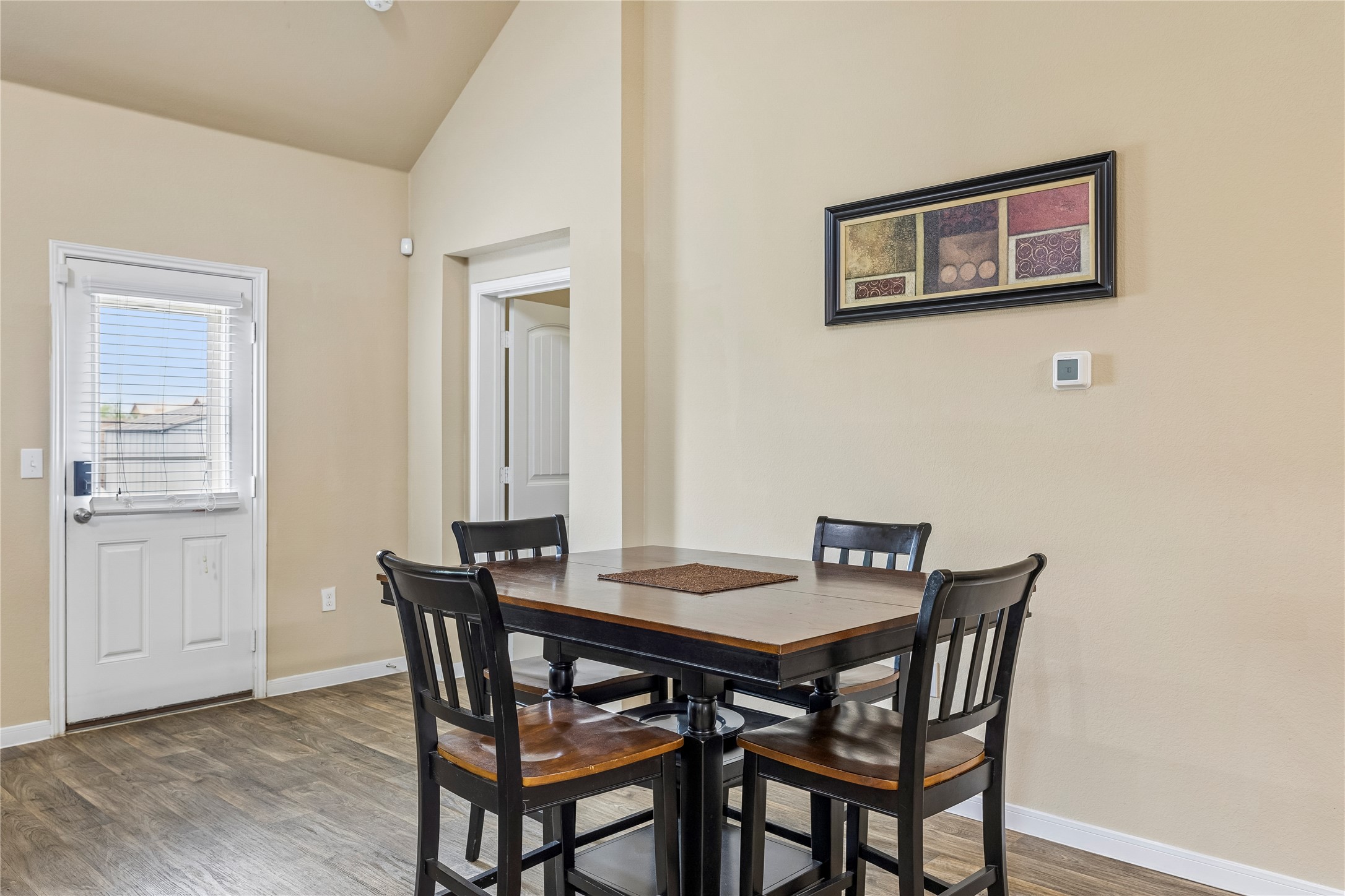 14409 Estuary Road Manor, TX 78653 - Photo 12 of 24 Vaulted ceiling over a dining area with wood-finish flooring