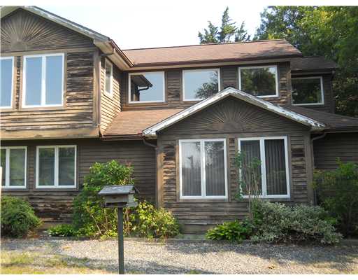 2630 Post Road South Kingstown, RI 02879 - Photo 2 of 20 Exterior Back. All of the windows on the second story are part of the master bedroom suite which has a generous bedroom, a cedar closet, a walk-in closet with two entrances, vanity room, and large bathroom w/whirlpool bath.