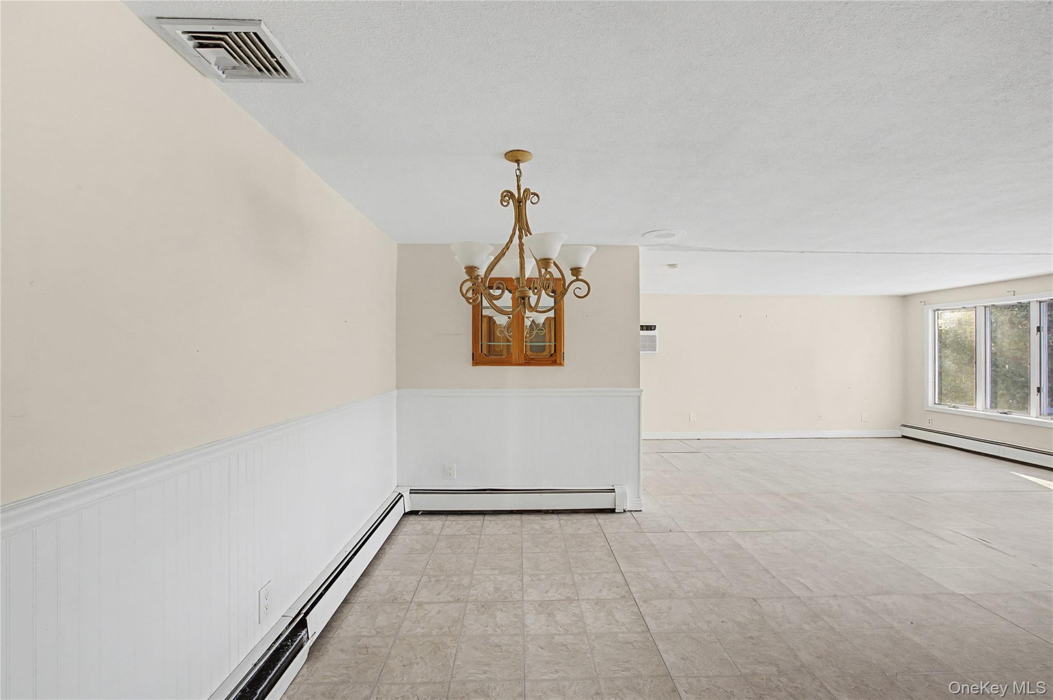 18 Woodbrook Drive Ridge, NY 11961 - Photo 11 of 33 wooden floor in an empty room with a window