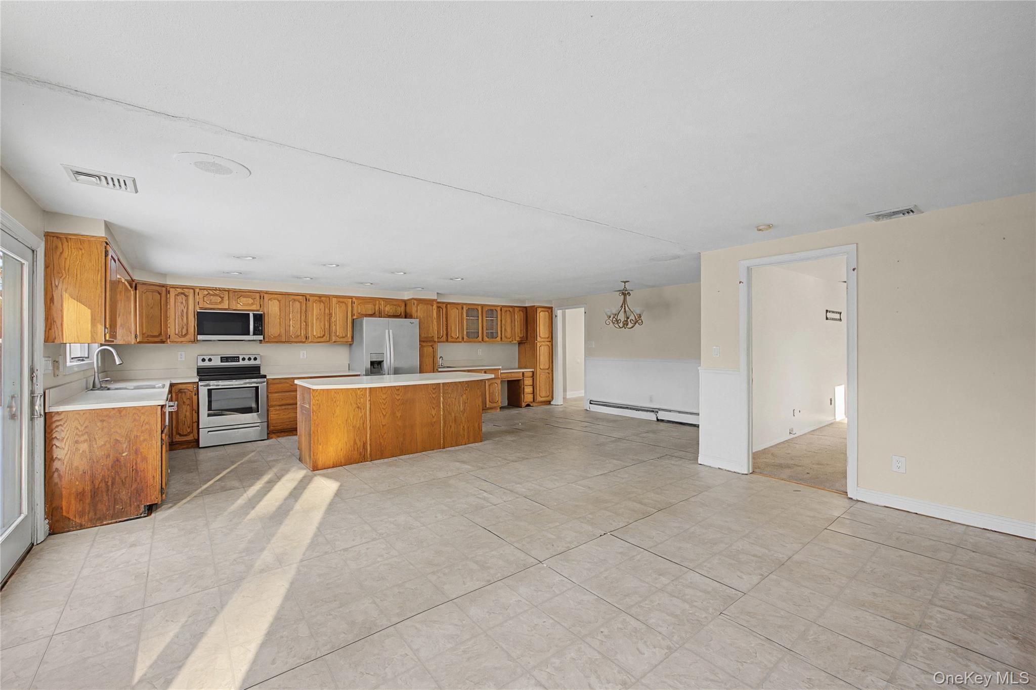 18 Woodbrook Drive Ridge, NY 11961 - Photo 18 of 33 a view of a kitchen with a sink and cabinets