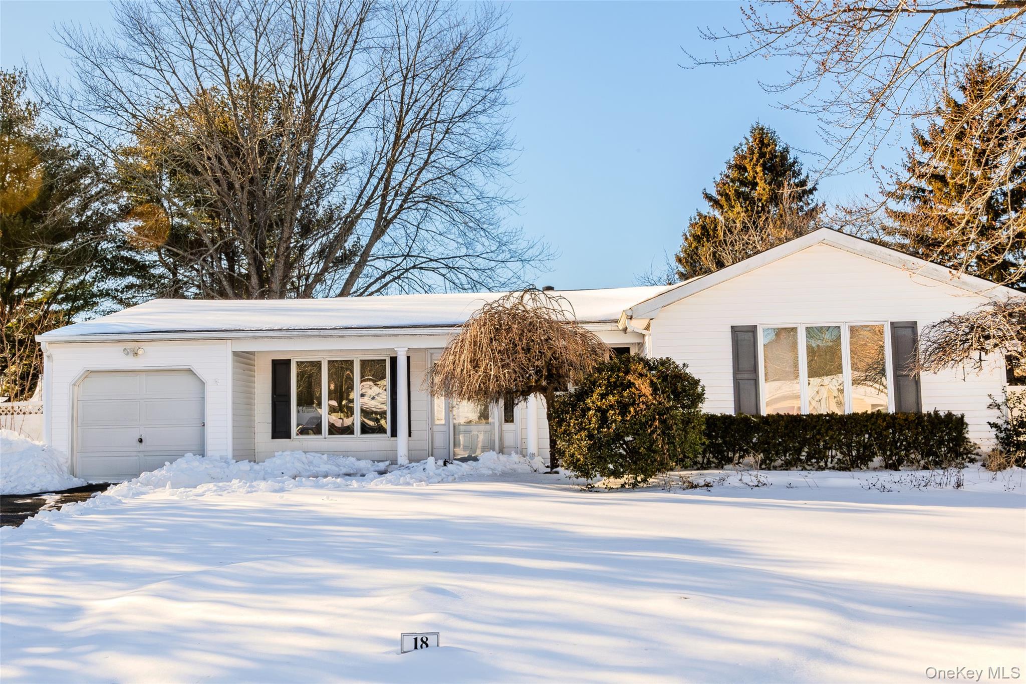 18 Woodbrook Drive Ridge, NY 11961 - Photo 2 of 33 a front view of a house with a yard