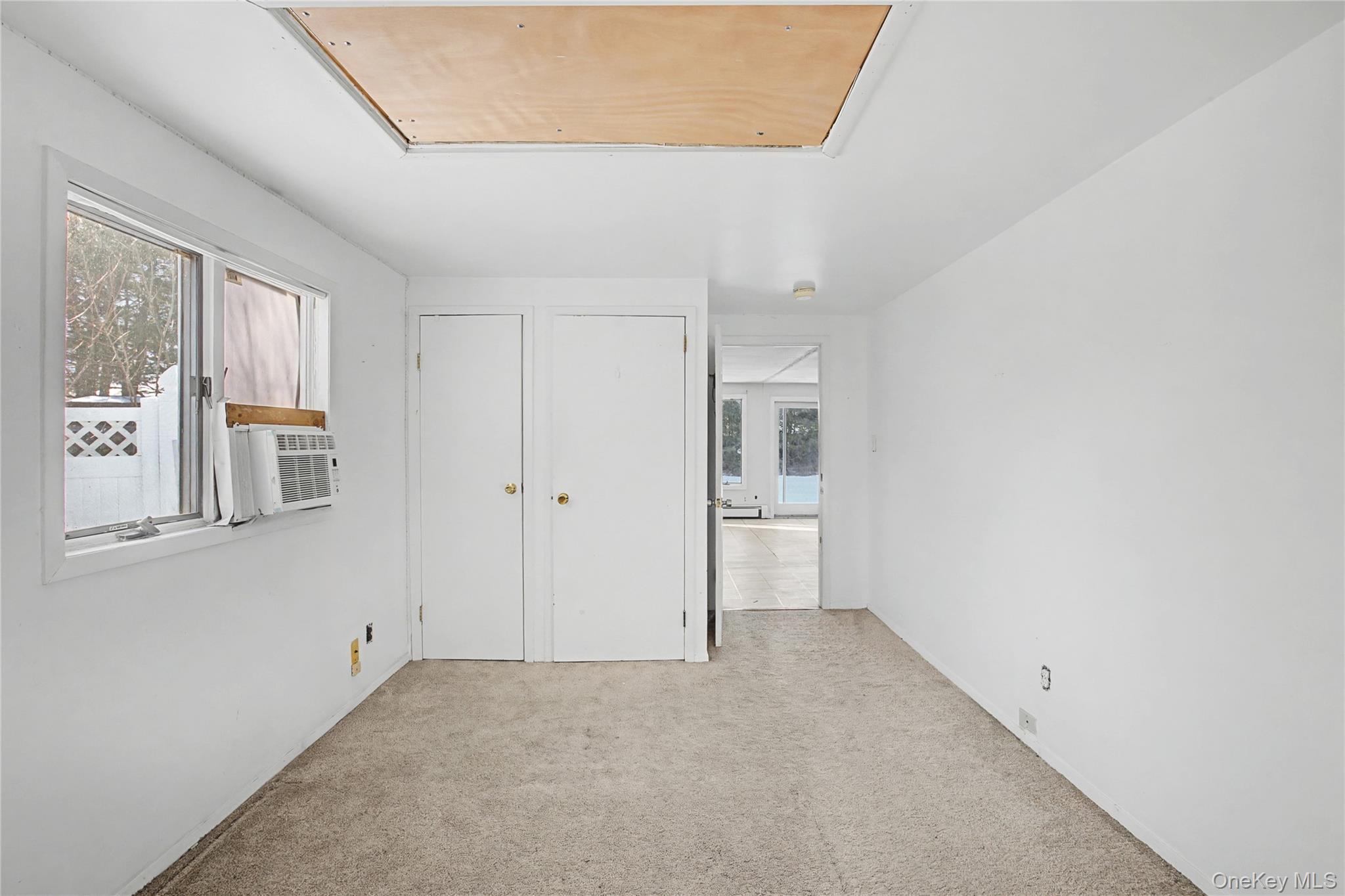 18 Woodbrook Drive Ridge, NY 11961 - Photo 22 of 33 a view of an empty room with a window
