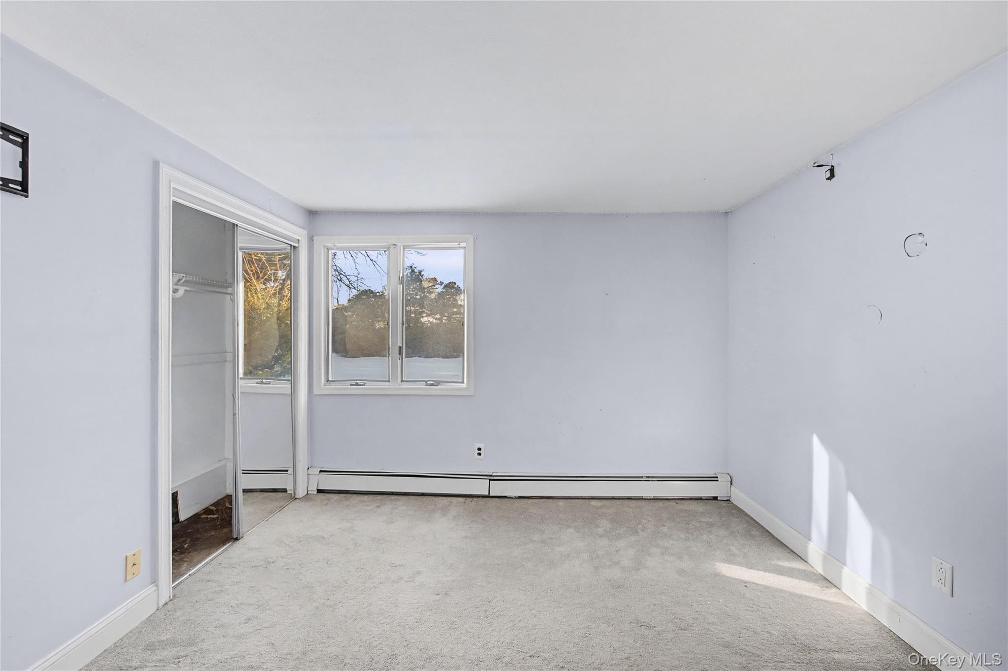 18 Woodbrook Drive Ridge, NY 11961 - Photo 25 of 33 a view of an empty room with a window