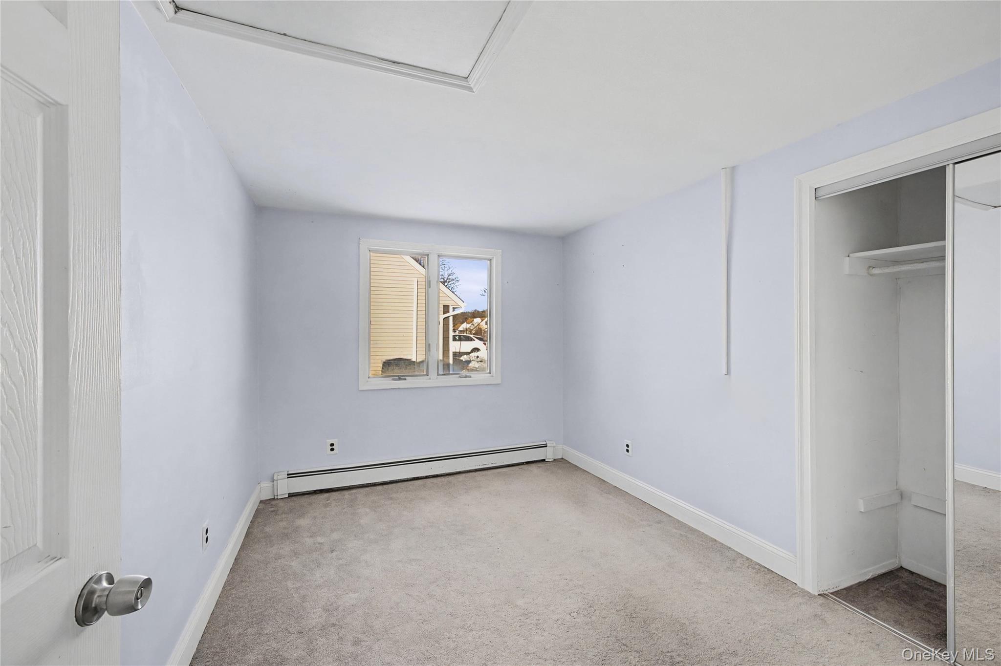18 Woodbrook Drive Ridge, NY 11961 - Photo 27 of 33 an empty room with a window
