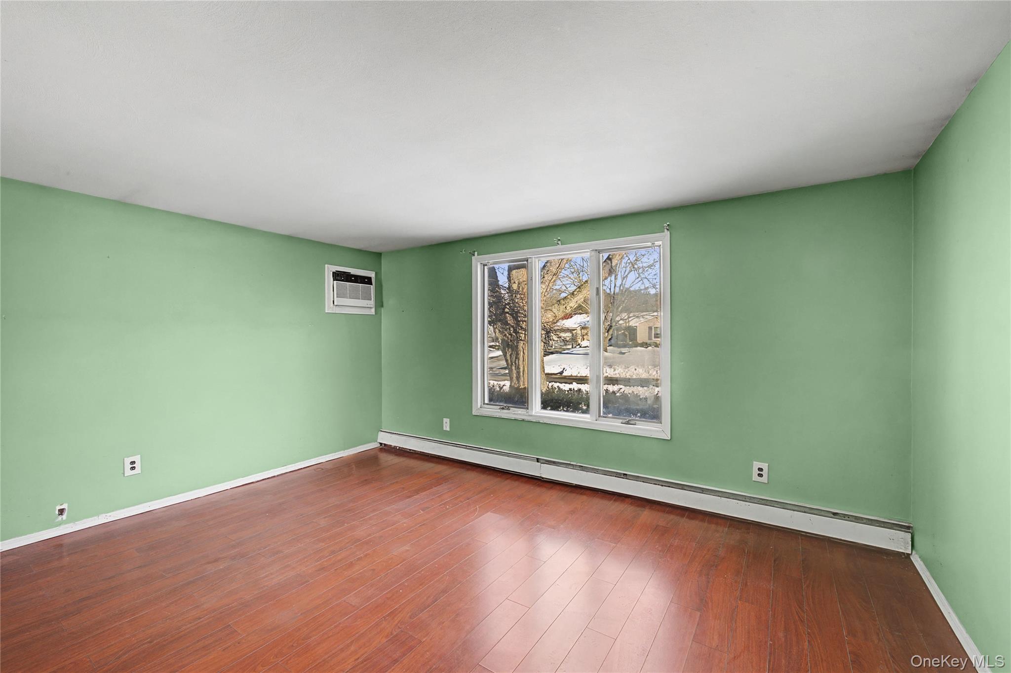 18 Woodbrook Drive Ridge, NY 11961 - Photo 28 of 33 an empty room with wooden floor and windows